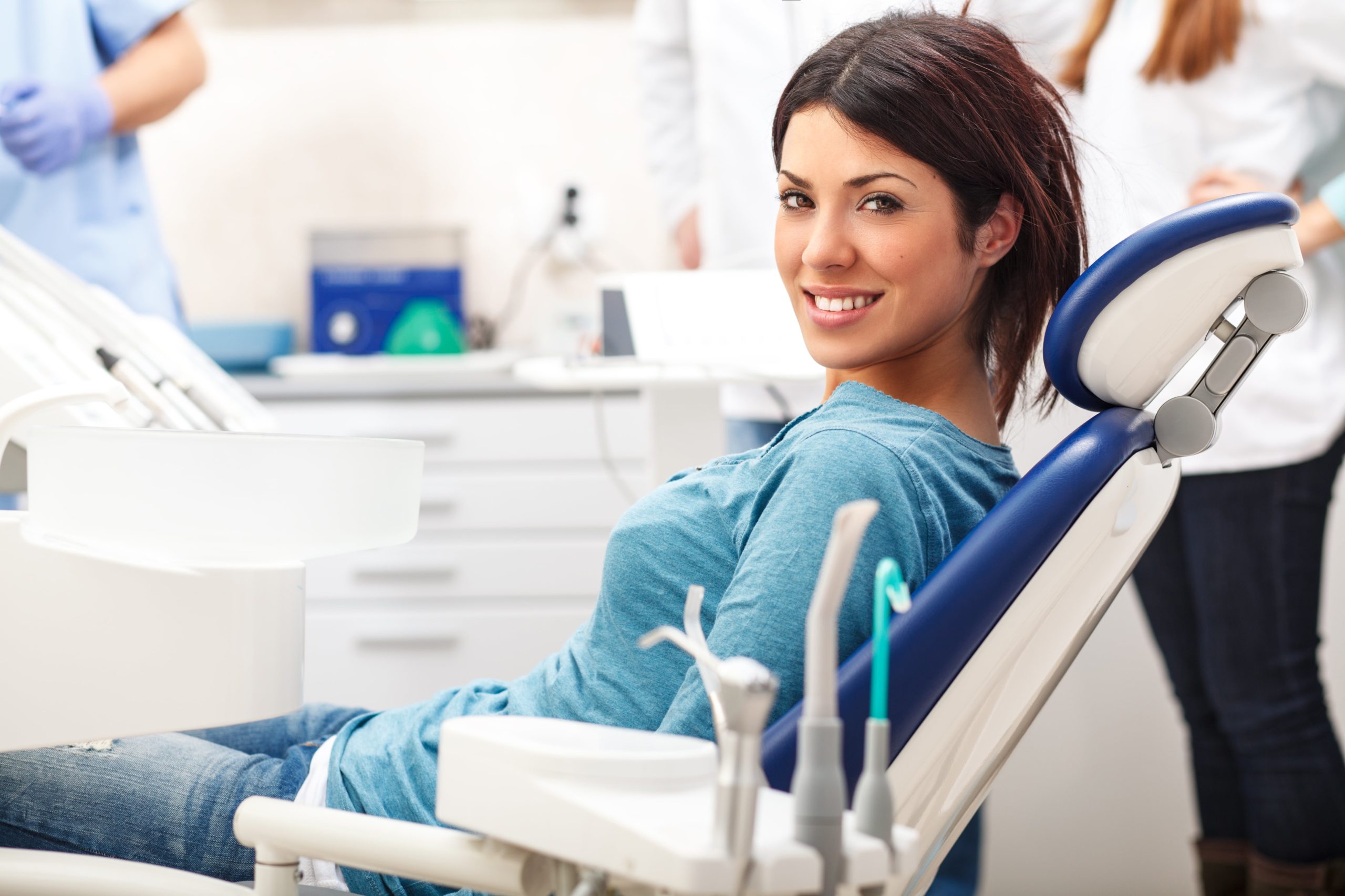 Women sitting in a dental chair smiling