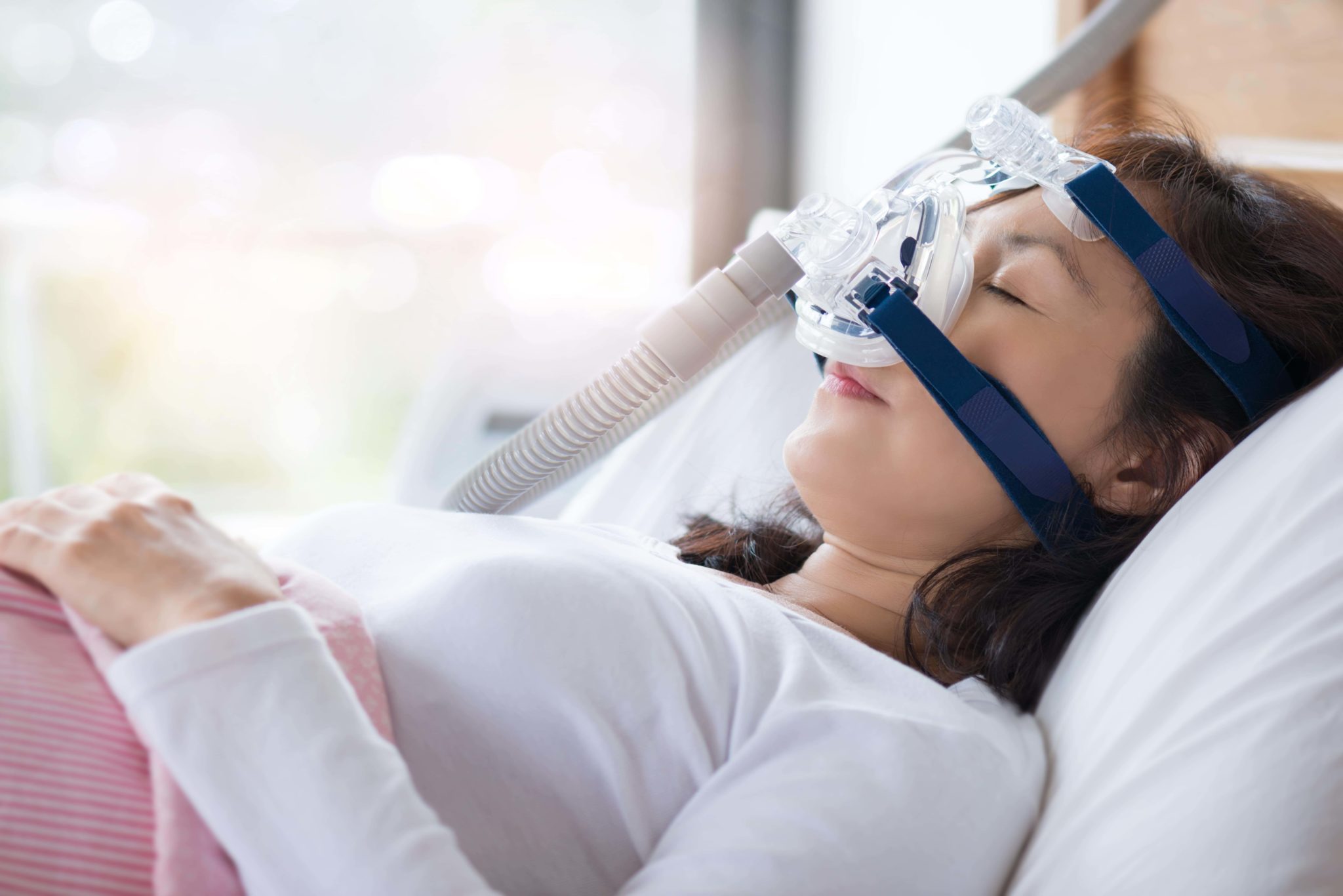 Women with a sleep apnea device on